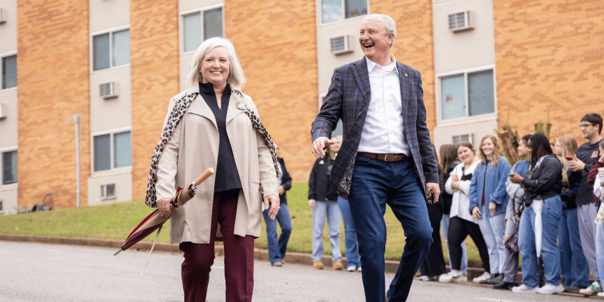 David and Tracie Shannon walking through the street during the homecoming parade
