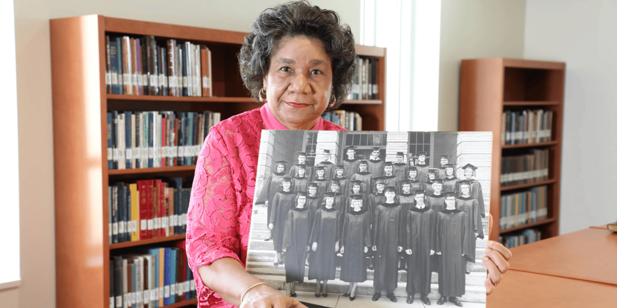 Dr. Elizabeth Saunders holds her 1967 graduation photo. She was Freed-Hardeman College's first Black graduate.