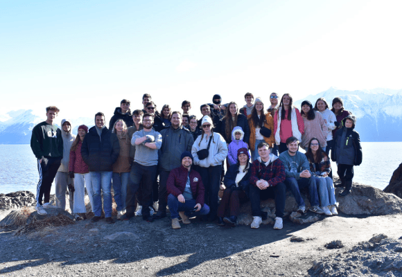 Group of FHU Students and professors posing on top of a mountain
