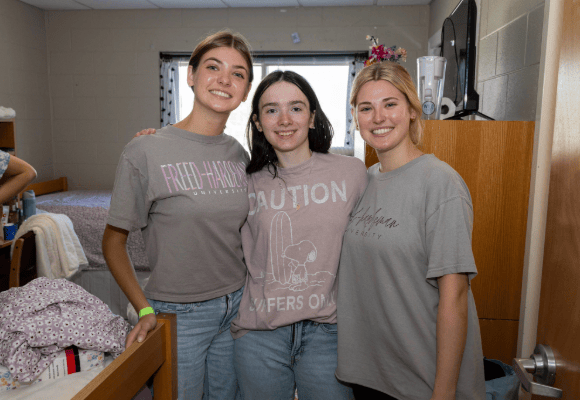Welcome Home Students gathering in one of their new dorm rooms