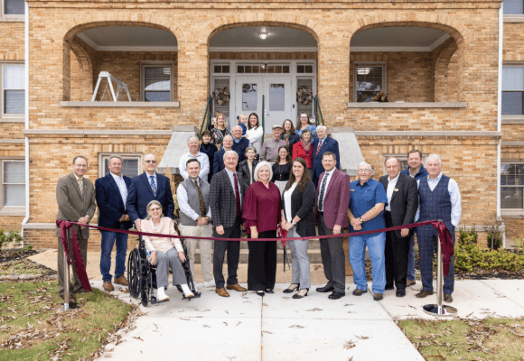 David and Tracie Shannon standing at the ribbon cutting for the newly renovated Hall Roland Dorm