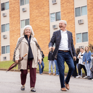 David and Tracie Shannon walking through the street during the homecoming parade