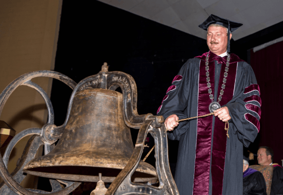 Close up as David Shannon tolls the bell for the first time