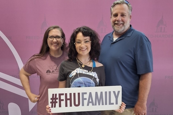 An FHU family poses together on move in day in August.