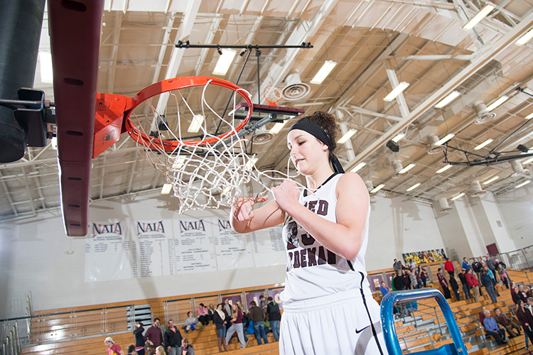Olympic silver medalist Grace Alonso cutting the net