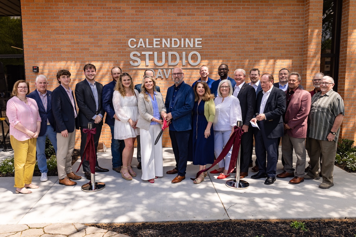 The Calendines, Davises and FHU faculty and administration cut the ribbon during the celebration of the Calendine-Davis Photo Studio.