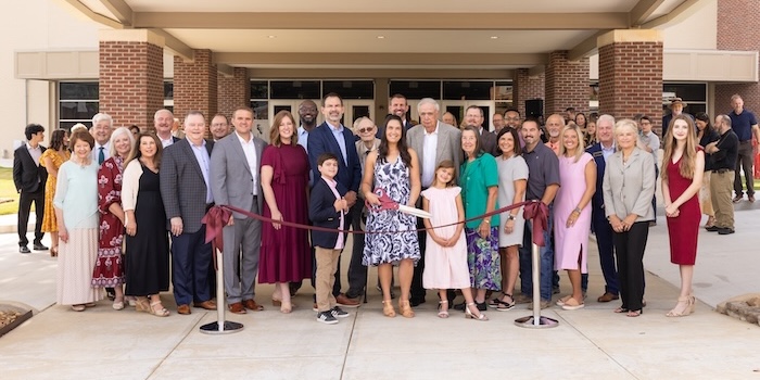 The Dryden family and FHU representatives cut the ribbon on the newly renovated David Thomas Dryden Auditorium.