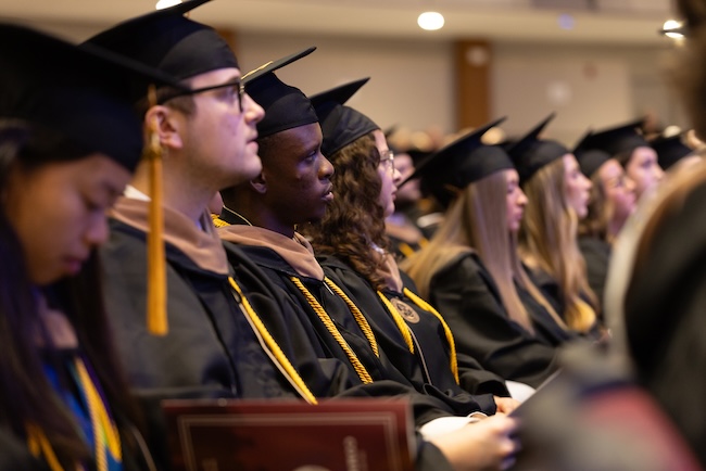 FHU graduates listen to the commencement address.