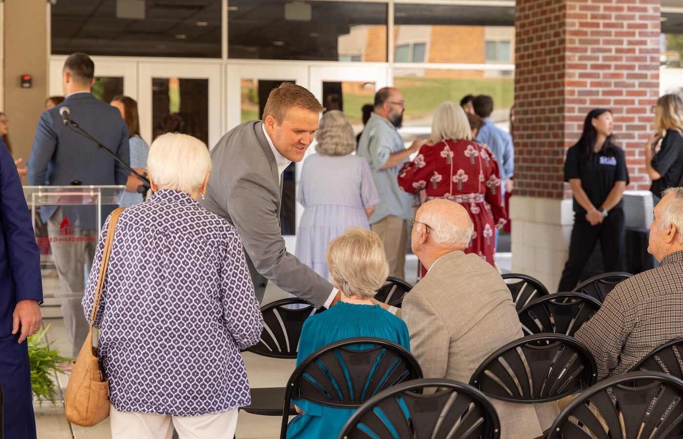 President Keith Harris greets visitors at the Dryden Auditorium ribbon cutting.