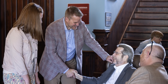Keith and Lyndsey Harris shaking hands with FHU Alumni