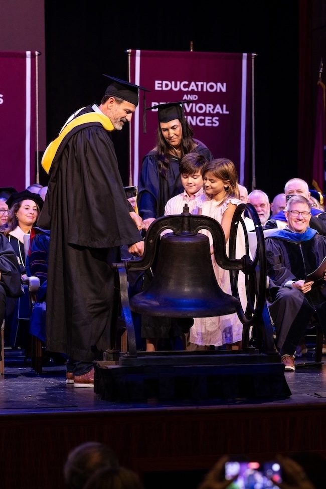 Jay and Hilde Dryden, along with their children, toll the bell to begin FHU's new academic year.