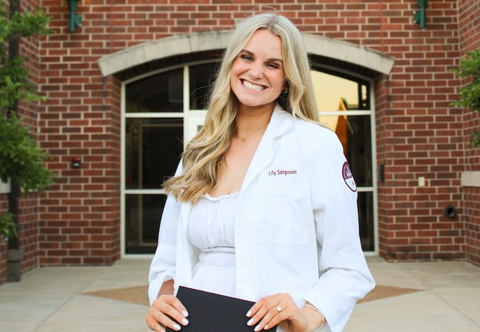 Lily Simpson Amar stands in front of the Anderson Science Center