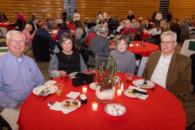 Benefit Dinner guests eat at a table in Brewer Sports Center