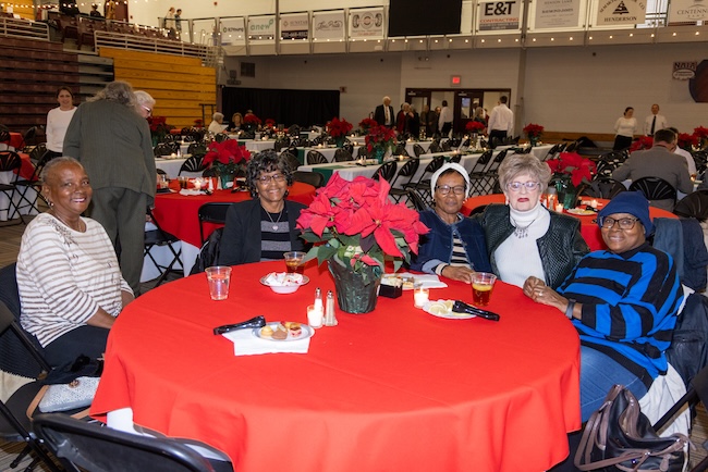 Five ladies sitting around a table in Brewer Sports Center