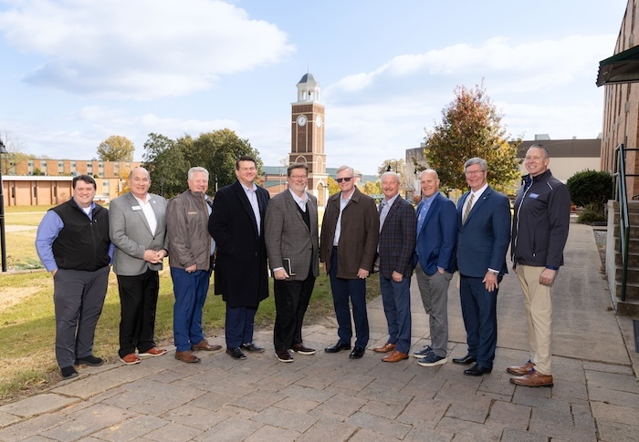Christian college and university presidents in front of FHU bell tower