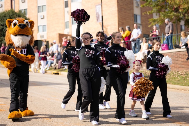 FHU cheerleaders and Lion walk in homecoming parade