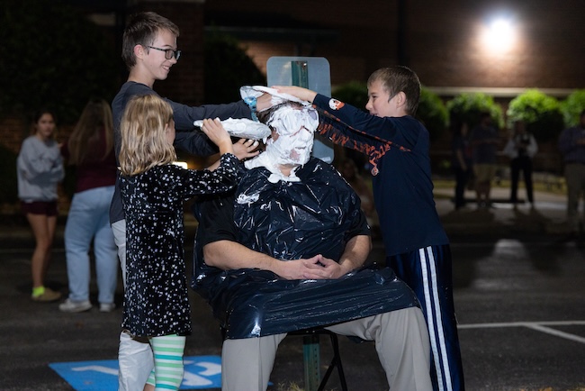 Three children throw pies in the face of an FHU professor