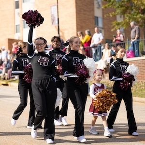 FHU cheerleaders walk down University Street