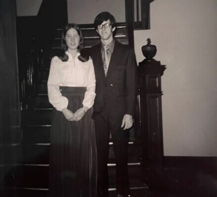 Two students at the foot of the McDaniel House staircase