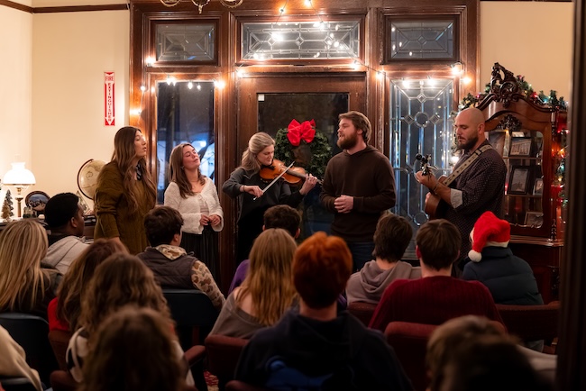 Musicians perform for guests in the foyer of the McDaniel House