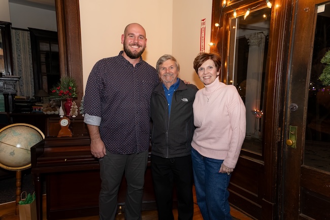 Grant Goodman poses with Robert and Lisa Naquin inside the McDaniel House