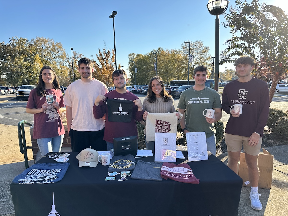 Members of FHU's personal selling class stand table to sell merchandise