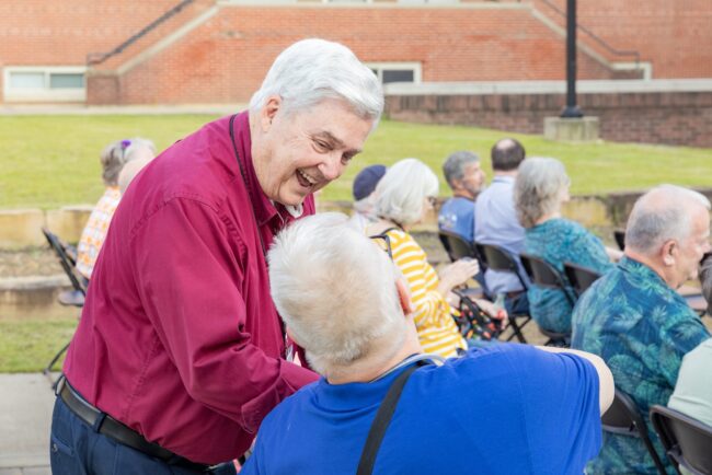 Dr. Milton Sewell shakes hands with a man