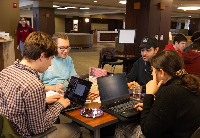 Students transcribe documents for Douglass Day event in the library