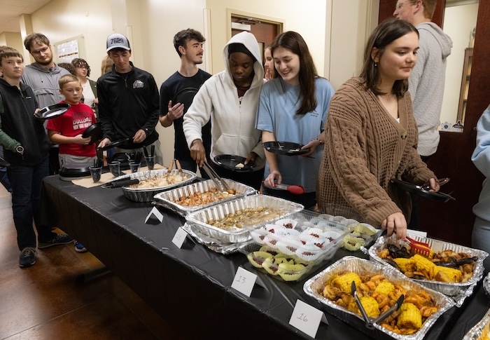 Students line up to get food for the FHU Epulor feast