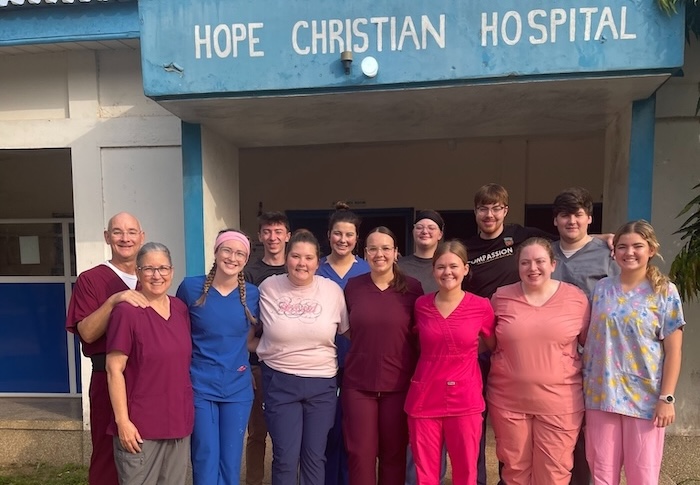 FHU nursing students and teachers stand in front of Hope Christian Hospital on a mission trip to Ghana
